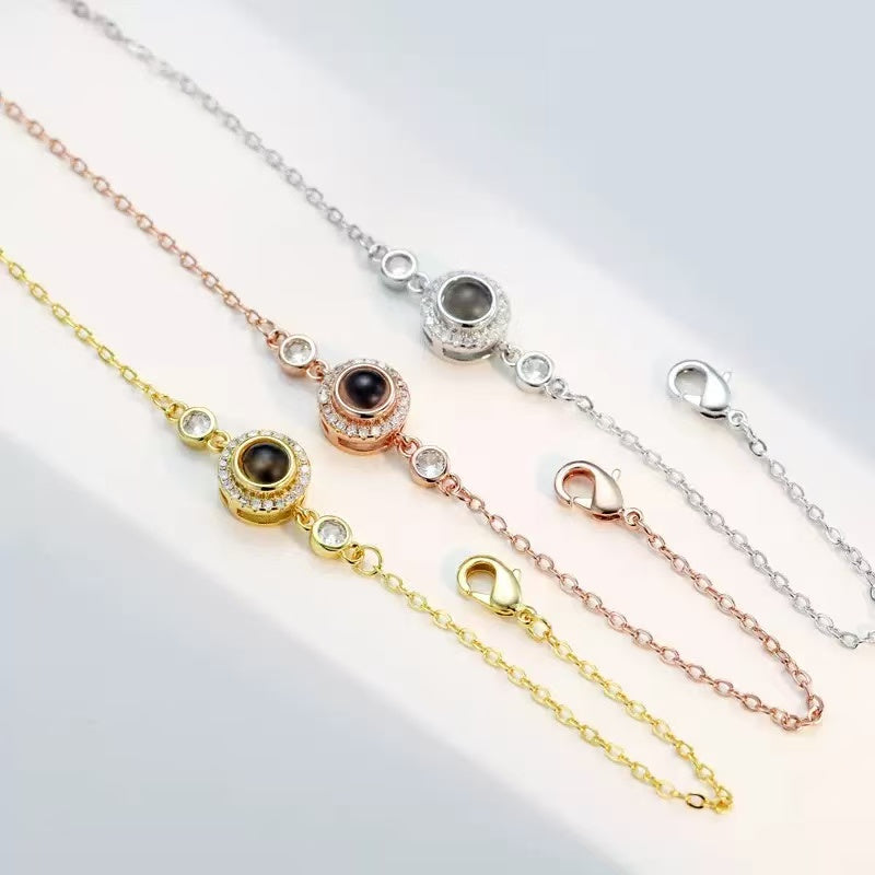 How photo projection bracelet works, showing hidden image inside charm with light